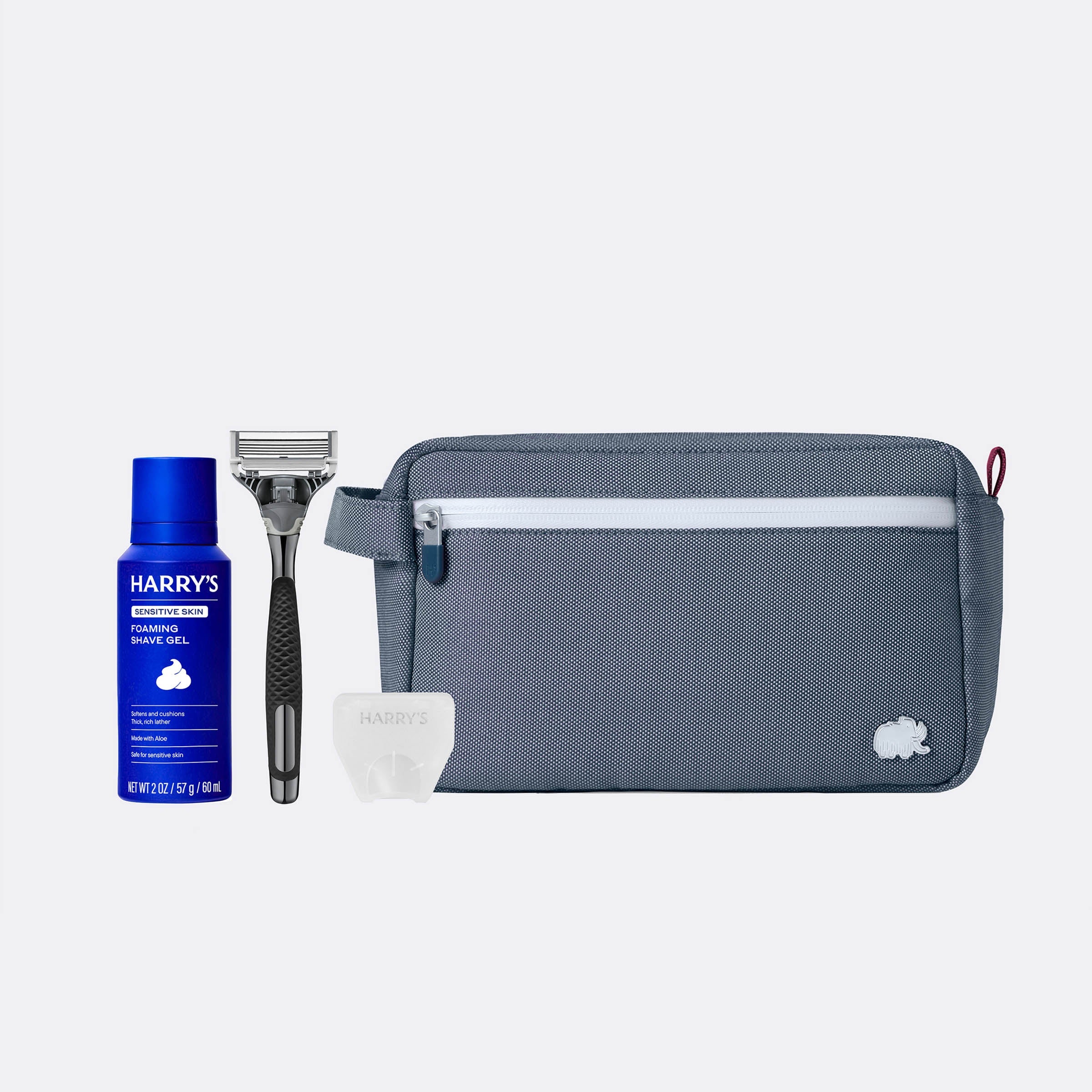 Grooming kit with Harry's shaving gel, razor, and pouch on a white background