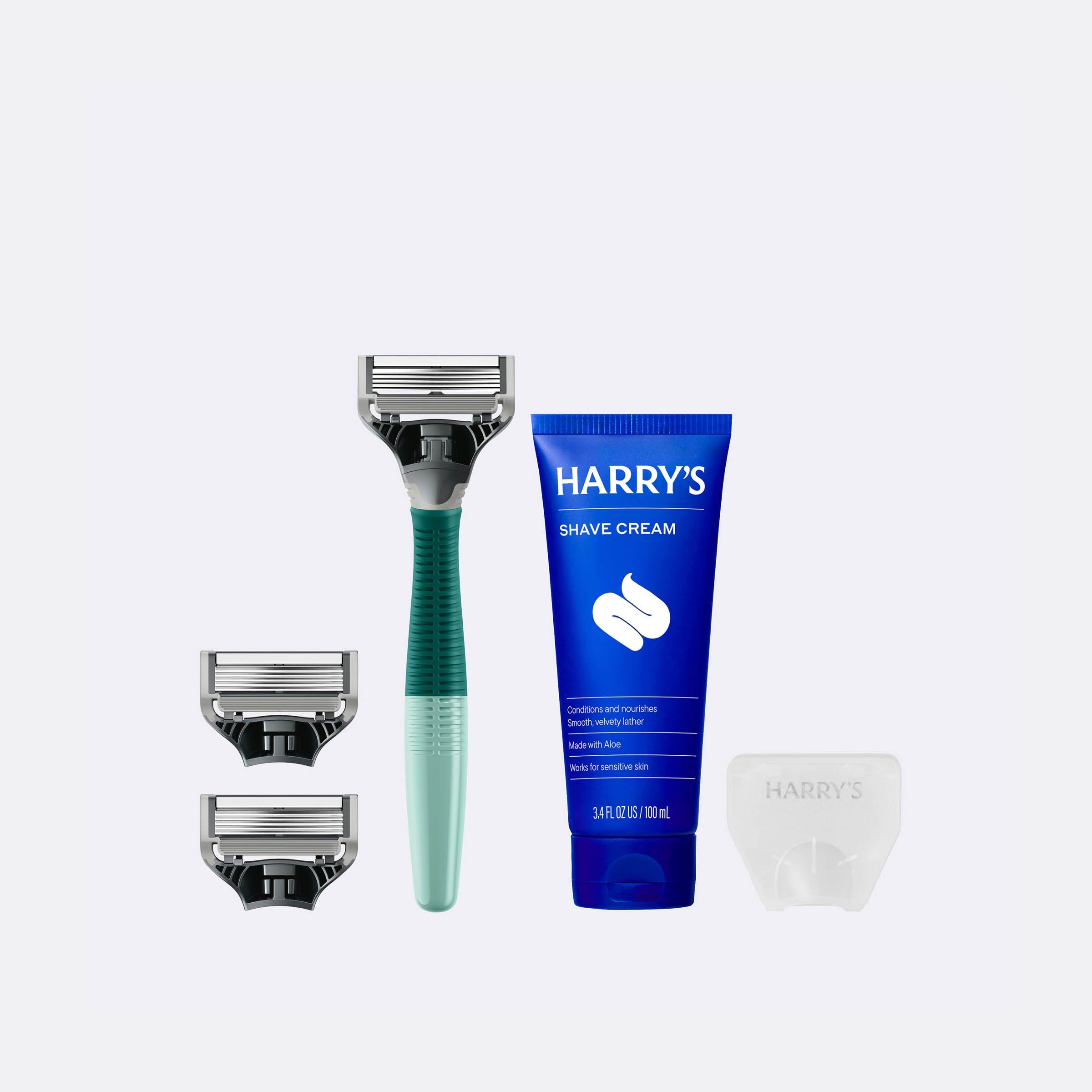 Harry's shaving kit with razor, cream, and razor heads on a white background