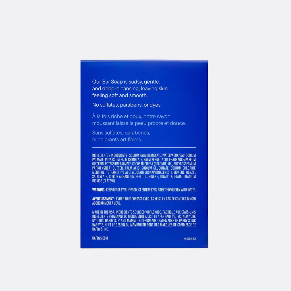 The back of a blue bar soap box by Harry's, displaying product details, ingredients, and warnings in white text, set against a light gray background.