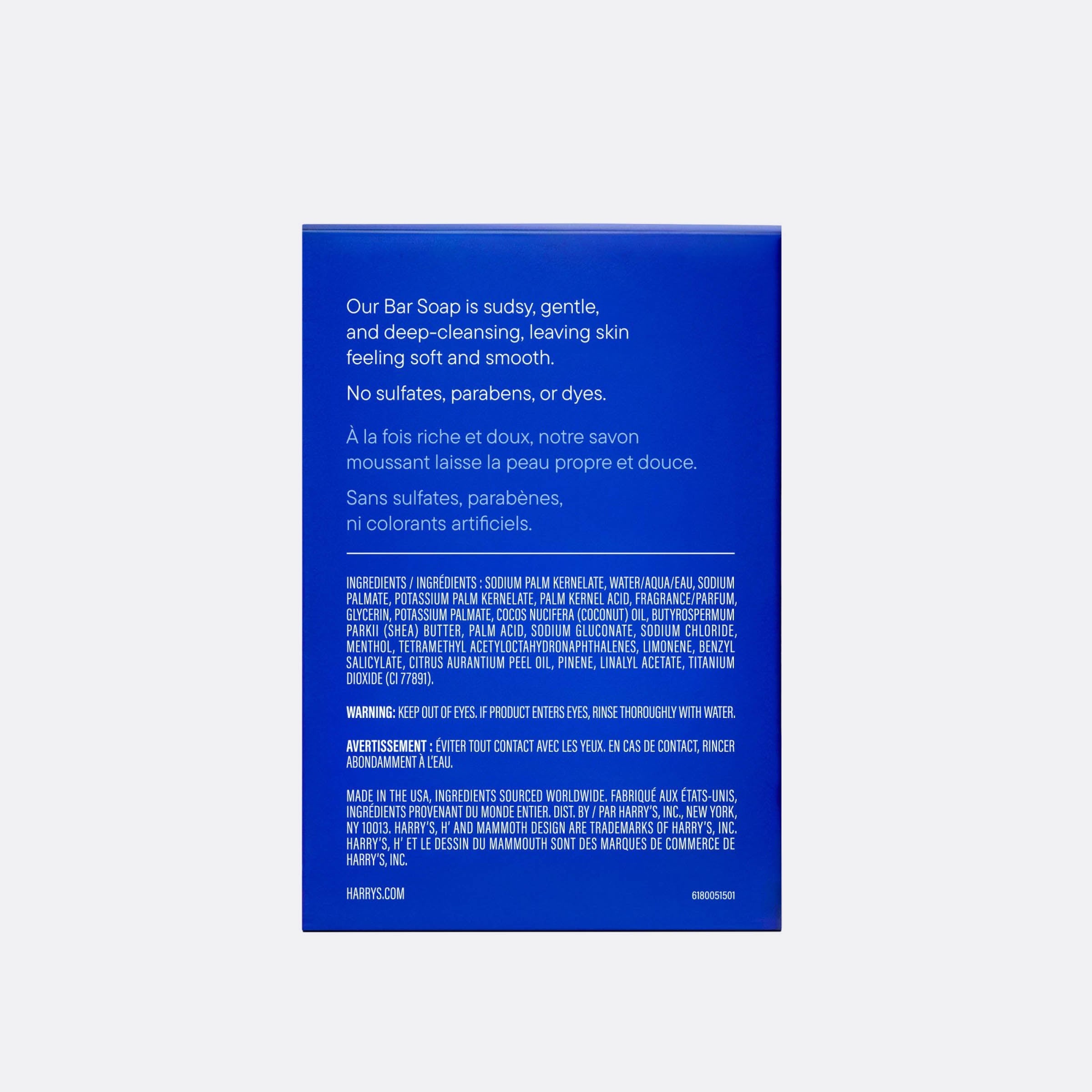The back of a blue bar soap box by Harry's, displaying product details, ingredients, and warnings in white text, set against a light gray background.