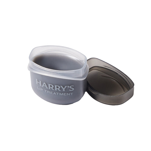 Gray container labeled 'Harry's Lip Treatment' on a white background