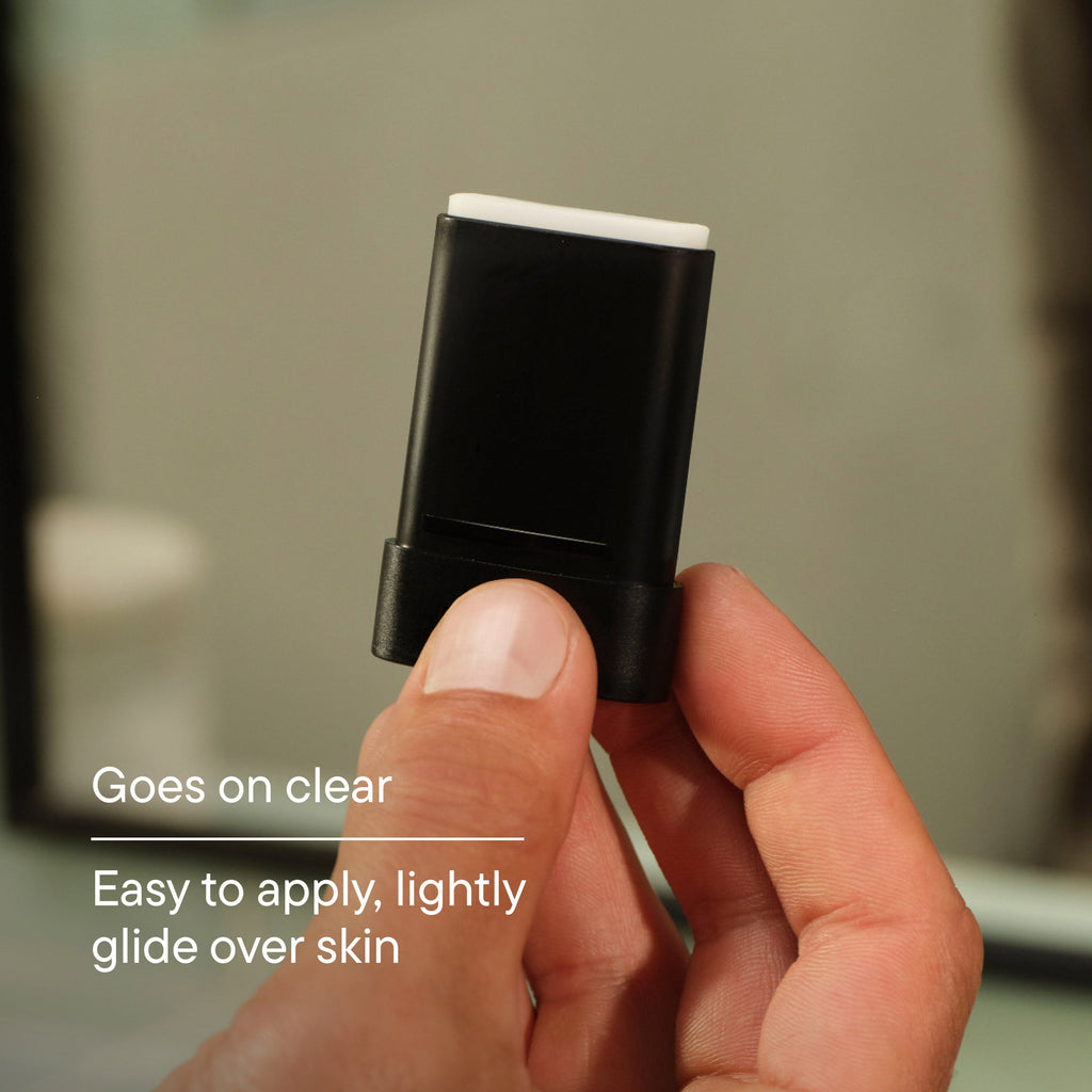 Hand holding a black and white stick with text about its application.
