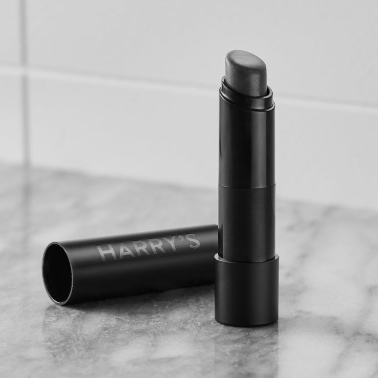 Lip Balm with 'HARRY'S' branding on a marble surface