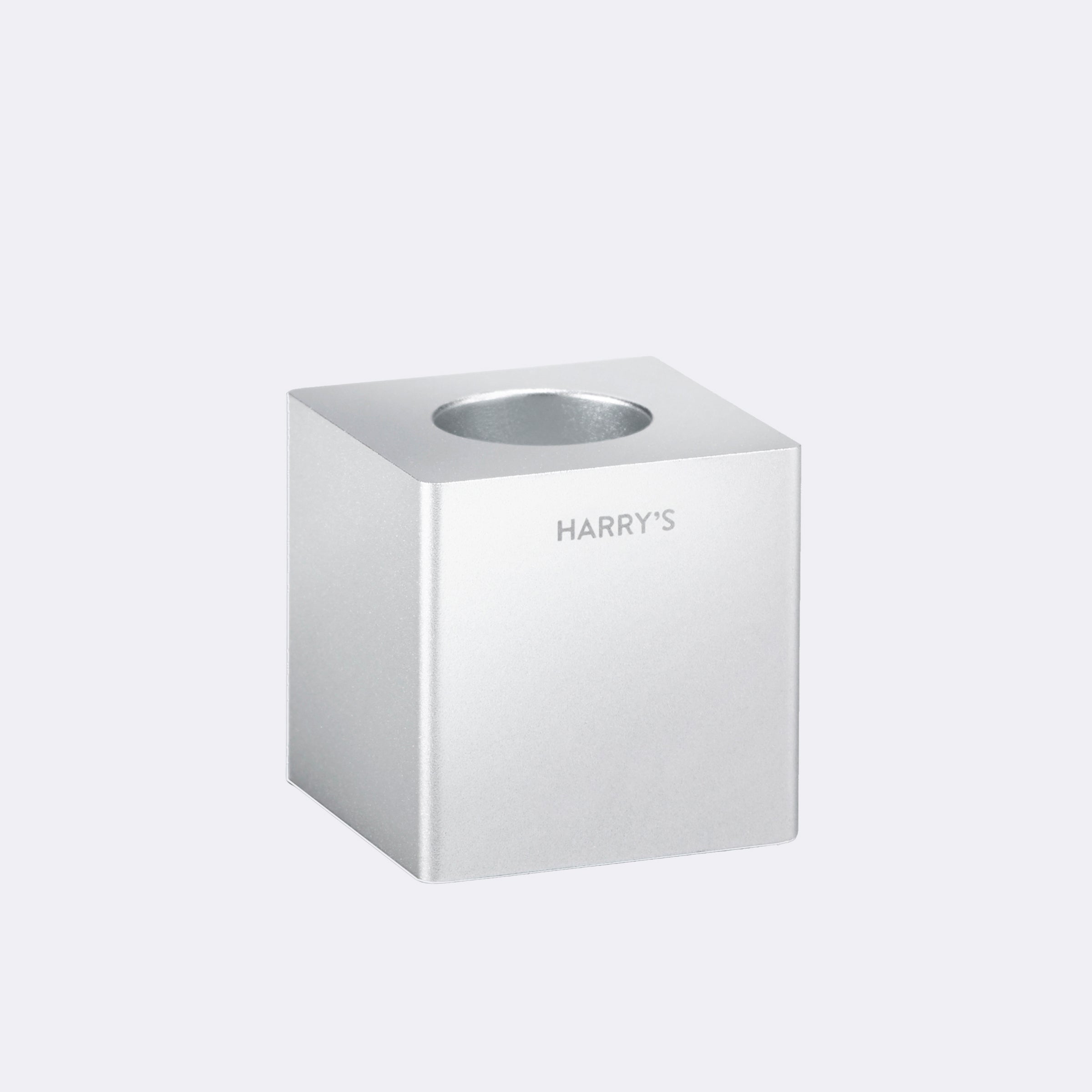 Harry's razor stand, a block of steel with a hole in the top to hold razors.