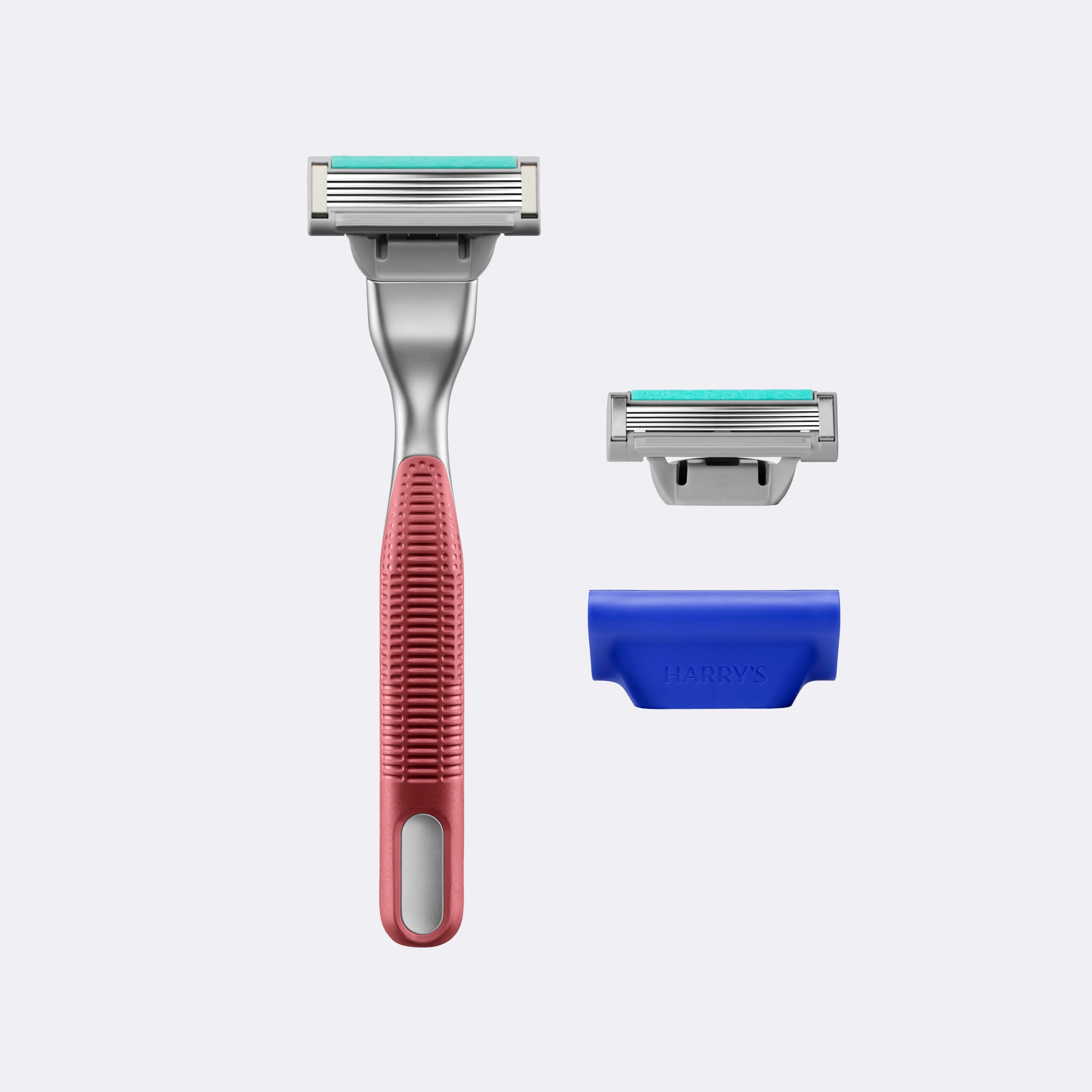 Shaving set with a red handle razor, blue stand, and silver razor head on a white background