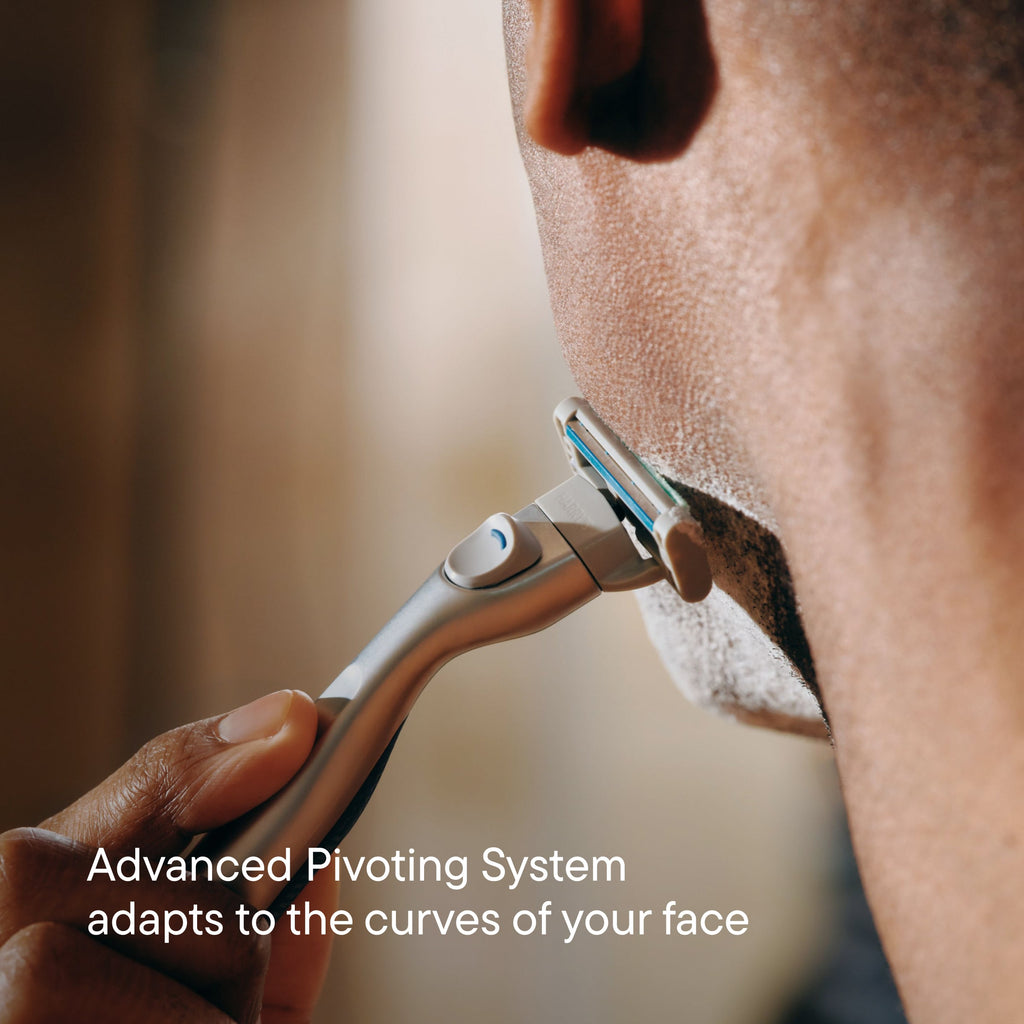 Person using a razor with an advanced pivoting system on their face.